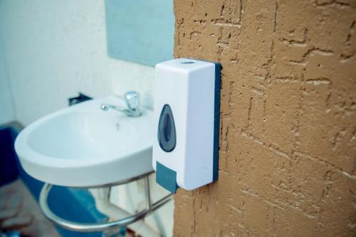 a bathroom with a sink and a speaker on a wall at Stand-alone- 2BR house in Dodoma in Dodoma