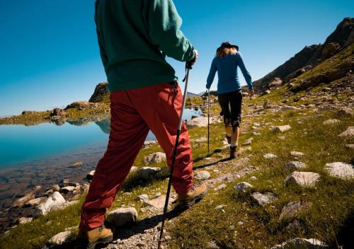 two people walking up a mountain with sticks at Soggiorno Bellin in Castel Ivano
