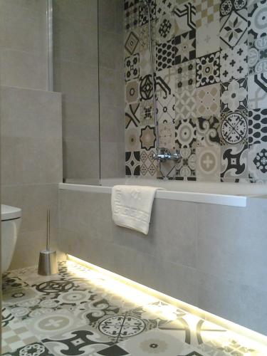 a bathroom with a shower and a tub and a toilet at Garden Corner in Krakow