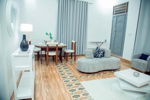 a living room with a table and a chair at Stand-alone- 2BR house in Dodoma in Dodoma