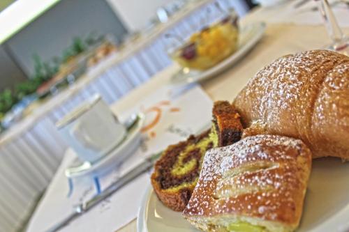a white plate with a loaf of bread on a table at Park Hotel in Castrocaro Terme