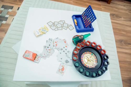 a table with playing cards and a clock on it at Stand-alone- 2BR house in Dodoma in Dodoma