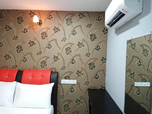 a bedroom with a bed with a brown and white wallpaper at USJ21@DALTON UNITED HOTEL in Kampong Batu Tiga Suku