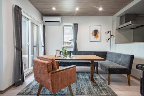 a dining room with a table and a couch at Mks 201 in Asahikawa