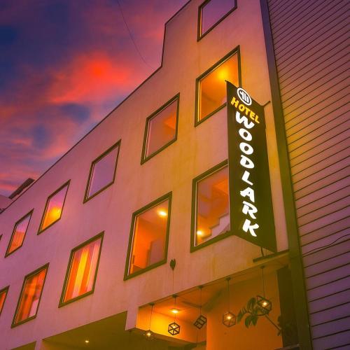 a building with a sign on the side of it at Hotel Woodlark !! Affordable luxury stay in Chandigarh Tricity ! Tourist Choice in Chandīgarh