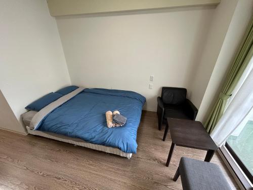 a bedroom with a bed with a teddy bear on it at Exsaison Chatan in Chatan