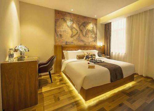 a hotel room with a large bed and a desk at James Joyce Coffetel Shenyang North Railway Station Qishan Road Metro Station in Shenyang