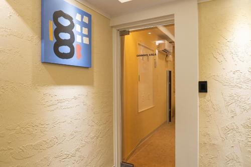 a hallway with a sign on the wall of a hospital at No25 Hotel Songnae Station in Bucheon