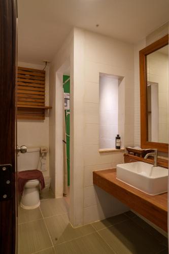 a bathroom with a sink and a toilet at Mata Pavilion in Loei