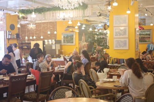 a group of people sitting at tables in a restaurant at Hotel Lemong in Seoul
