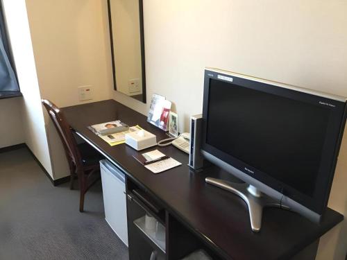 a desk with a television on top of it at Hotel Gran View Okinawa in Naha