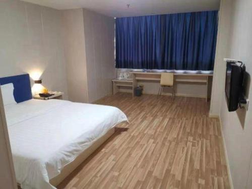 a hotel room with a bed and a television at 7 Days Inn Changzhou Yancheng Technology Metro Station in Changzhou