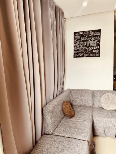a living room with a couch and a curtain at Residential Villa in ELyu in Bacnotan