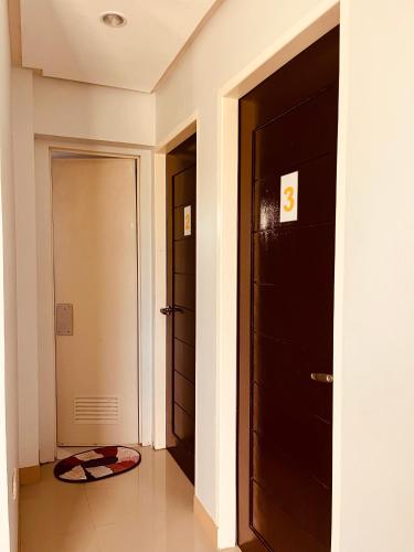 a hallway with two doors and a rug on the floor at Residential Villa in ELyu in Bacnotan