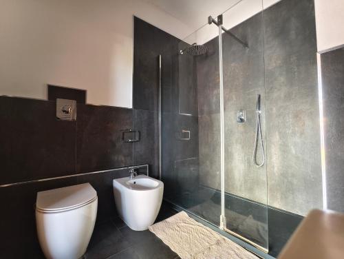 a bathroom with a toilet and a glass shower at Villetta del Sole in La Maddalena