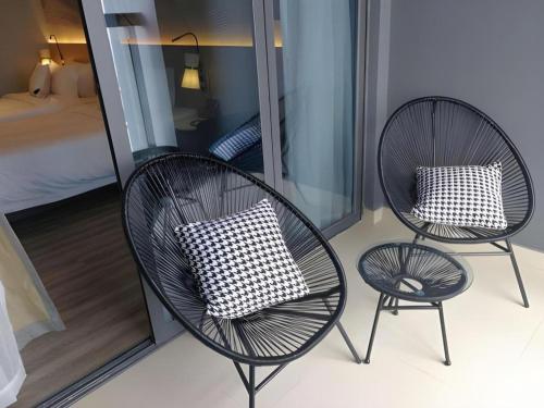 two chairs with pillows sitting on a balcony at Imin Hotel in Huadu