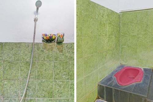 a shower with a pink tub in a green tiled bathroom at Hotel O Bagus Jaya Hotel in Semarang