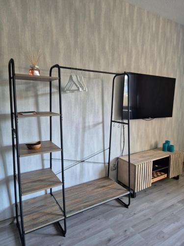 a black bunk bed with a tv and a shelf at Studio Apartment in Oberhausen