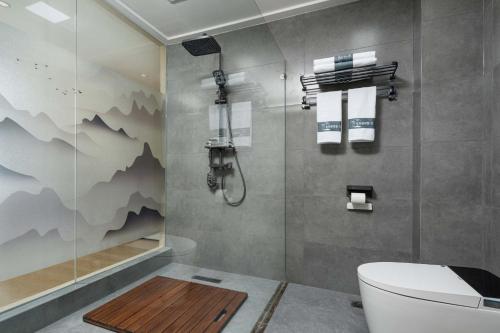 a bathroom with a shower with a toilet and a sink at Enjoy the panoramic view of the rice fields (Longsheng Longji Terraces Branch) in Heping