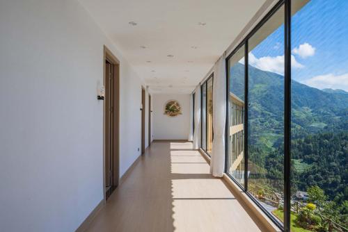 a corridor of a building with large windows at Enjoy the panoramic view of the rice fields (Longsheng Longji Terraces Branch) in Heping