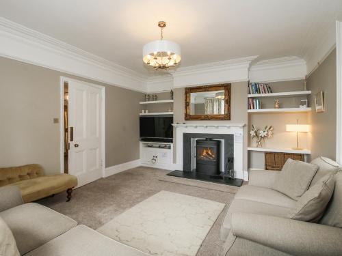 a living room with a couch and a fireplace at The Old Vicarage in Leominster