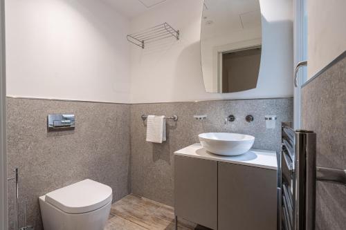 a bathroom with a toilet and a sink at Old Theatre Suites - Panarea in Valletta