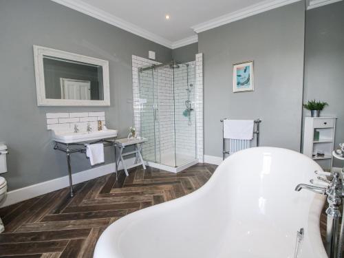 a bathroom with a tub and a sink at The Old Vicarage in Leominster