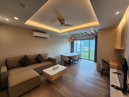 a living room with a couch and a table at The Regent ​Phuket ​Serviced Apartment ​Kamala ​Beach in Kamala Beach