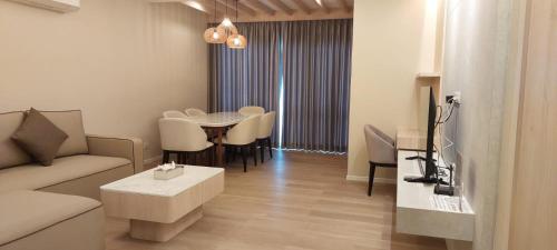 a living room with a couch and a table at The Regent ​Phuket ​Serviced Apartment ​Kamala ​Beach in Kamala Beach
