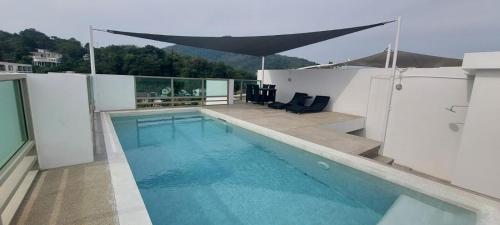 a swimming pool on the roof of a house at The Regent ​Phuket ​Serviced Apartment ​Kamala ​Beach in Kamala Beach