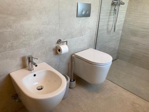a bathroom with a sink and a toilet and a shower at Apartments Aura & Nova in Aue-Bad Schlema
