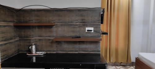 a bathroom with a wooden wall with a sink at Kaziranga Homestay in Guwahati