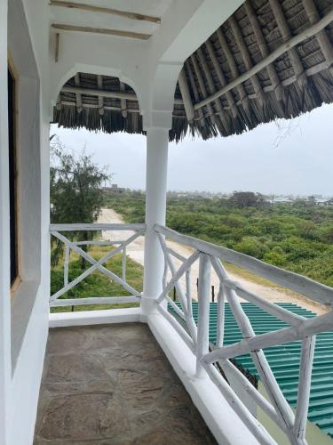 a balcony with a view of the ocean at Poa Poa Villas in Watamu