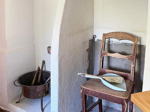 a kitchen with a chair and a bowl and a spatula at 4 person holiday home in FURUBY in Furuby