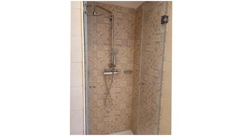 a shower with a glass door in a bathroom at Masi suite in Monopoli