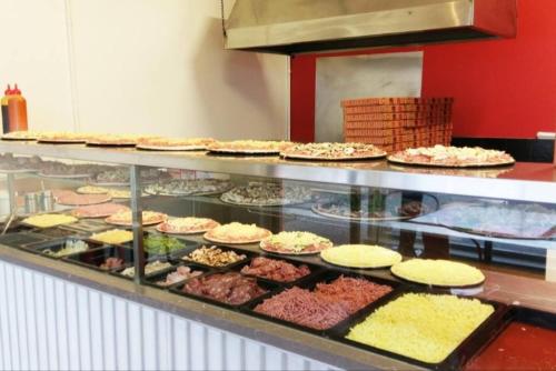 a display case with many different types of food at GREENVIEW, BFast,WiFi,Fetch, Walk2Pizza,Liquor in Bell Post Hill