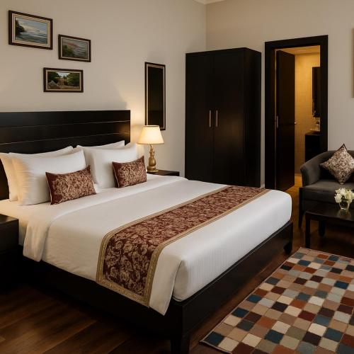 a hotel room with a large bed and a chair at The Garnet Resort - Top Rated & Most Awarded Property in Vrindavan in Vrindāvan