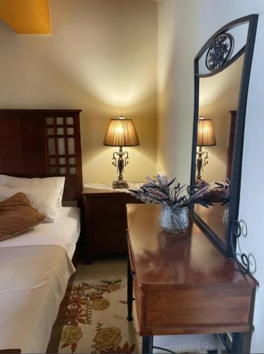 a bedroom with a bed and a table with a mirror at Mountain View in Synikia Mesi Trikalon