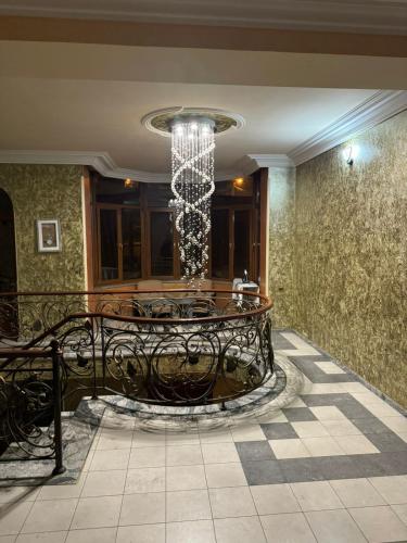 a dining room with a chandelier in a building at Kajaznuni hotel-hostel in Yerevan