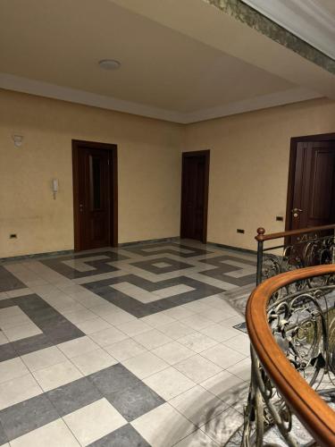 a room with a tiled floor and two doors at Kajaznuni hotel-hostel in Yerevan