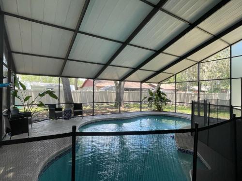 a swimming pool with a retractable roof at Pool Home at Busch Gardens USF in Tampa