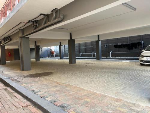 an empty parking lot in front of a building at The studios at Forest Glen in Johannesburg