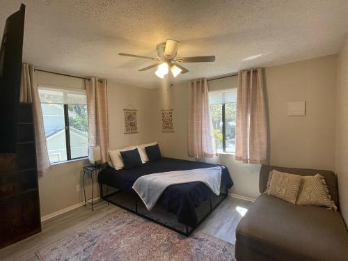a bedroom with a bed and a ceiling fan at Pool Home at Busch Gardens USF in Tampa