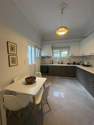 a kitchen with a table and chairs in a room at Olivia 42 in Nafpaktos