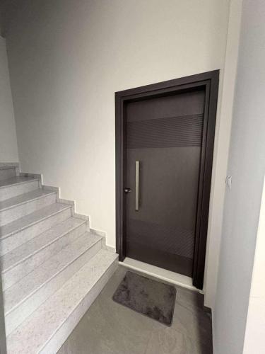 a door leading to a stairway with a metal door sidx sidx at Olivia 42 in Nafpaktos