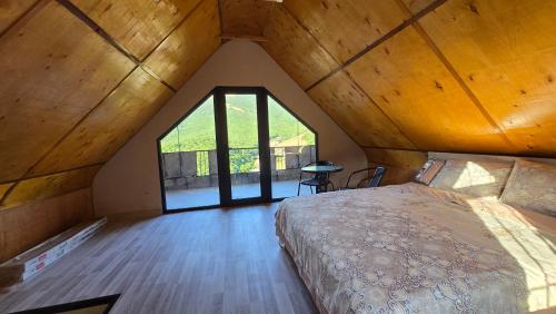 a bedroom with a large bed in a attic at Start Rest House in Hrazdan