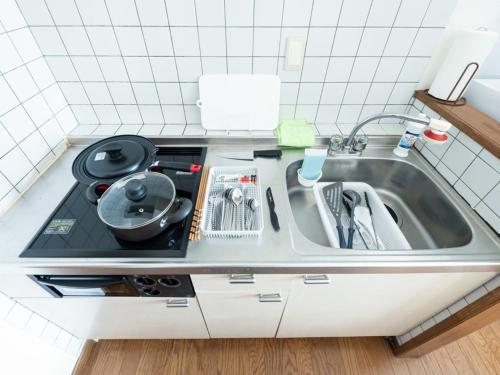 un lavello con stendibiancheria accanto di Hongo Street House - Vacation STAY 8636 a Sapporo