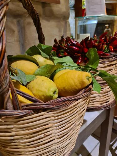 a basket filled with lemons and other fruits and vegetables at Mare e Relax in Mola di Bari