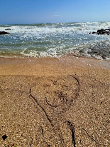 a heart drawn in the sand on the beach at Mare e Relax in Mola di Bari