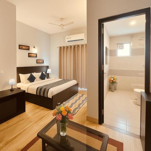 a hotel room with a bed and a table at The Garnet Resort - Top Rated & Most Awarded Property in Vrindavan in Vrindāvan